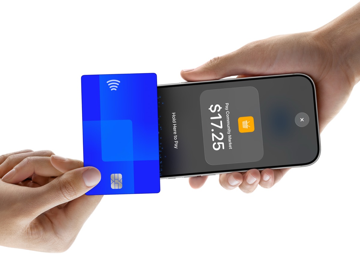 A customer holds a contactless card to an iPhone to pay